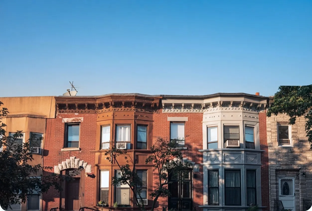 A row of red-brick buildings with bay windows